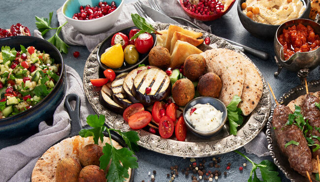 Arabic food assortment on dark background.